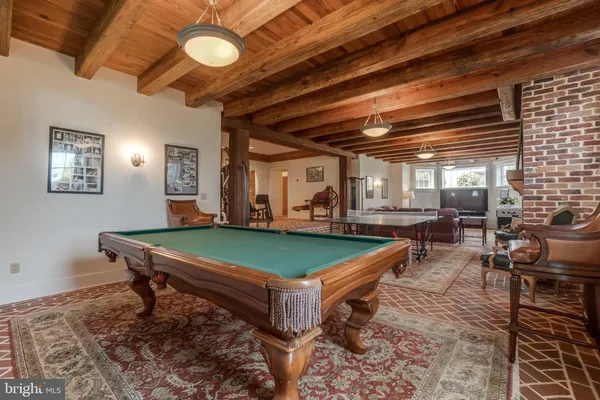 a view of a lake with a table and chairs next to a yard