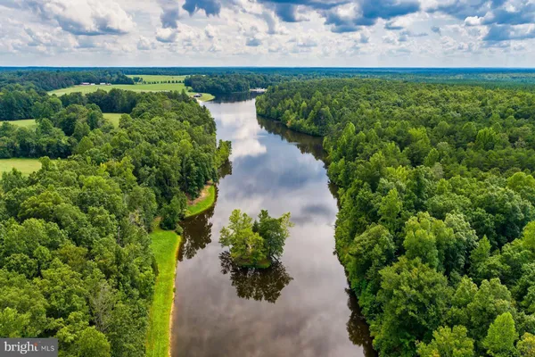 an aerial view of residential houses with outdoor space and lake view