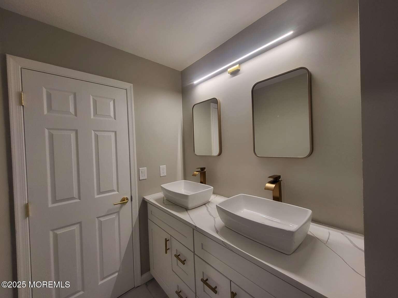 66 Potter Road Freehold, NJ 07728 - Photo 16 of 25 a en suite bathroom with a double vanity sink and a mirror
