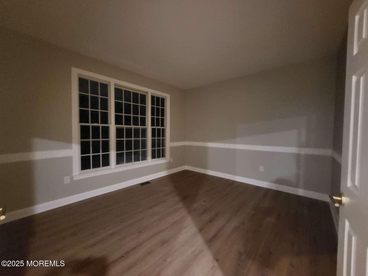 66 Potter Road Freehold, NJ 07728 - Photo 20 of 25 a view of an empty room with wooden floor and a window