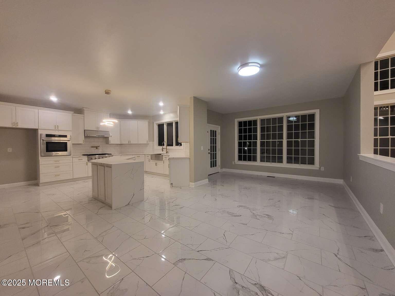 66 Potter Road Freehold, NJ 07728 - Photo 2 of 25 a view of a kitchen with refrigerator and chairs