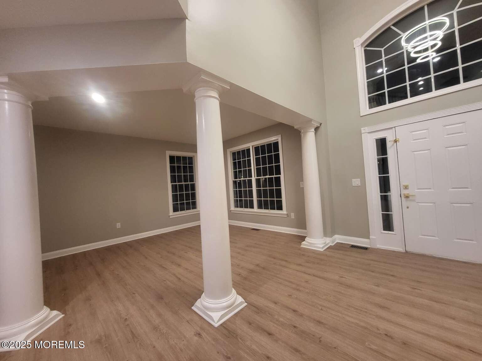 66 Potter Road Freehold, NJ 07728 - Photo 5 of 25 an empty room with wooden floor and windows