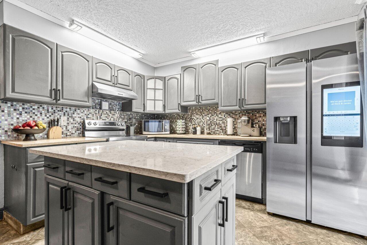 22180 Boca Rancho Drive, Unit B Boca Raton, FL 33428 - Photo 16 of 22 a kitchen with stainless steel appliances a sink and cabinets