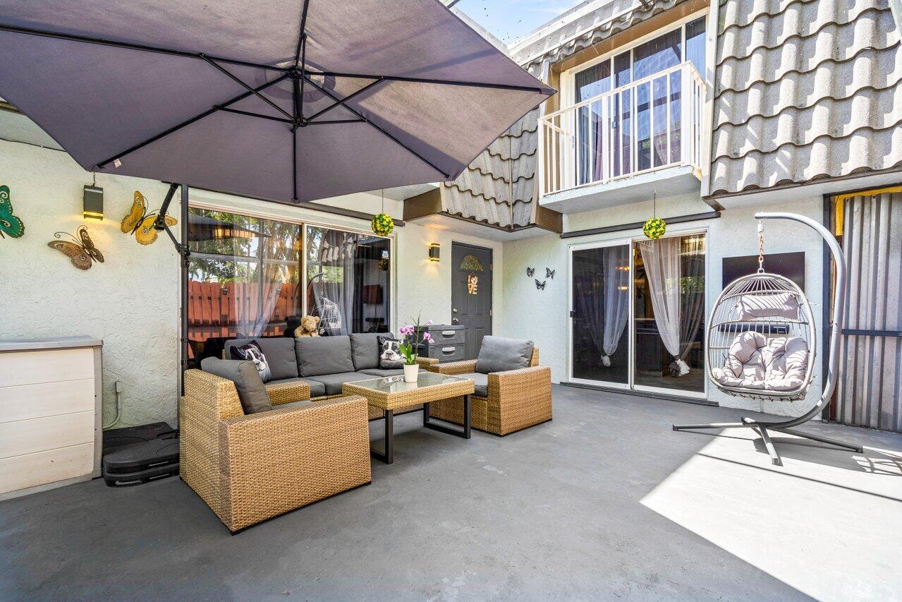 22180 Boca Rancho Drive, Unit B Boca Raton, FL 33428 - Photo 3 of 22 a living room with fireplace furniture and a umbrella