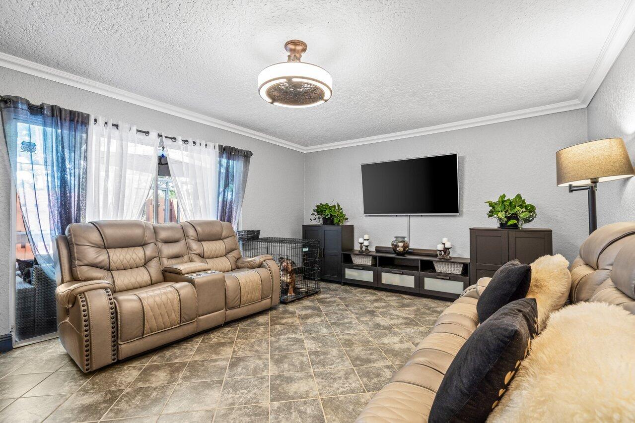 22180 Boca Rancho Drive, Unit B Boca Raton, FL 33428 - Photo 7 of 22 a living room with furniture and a flat screen tv