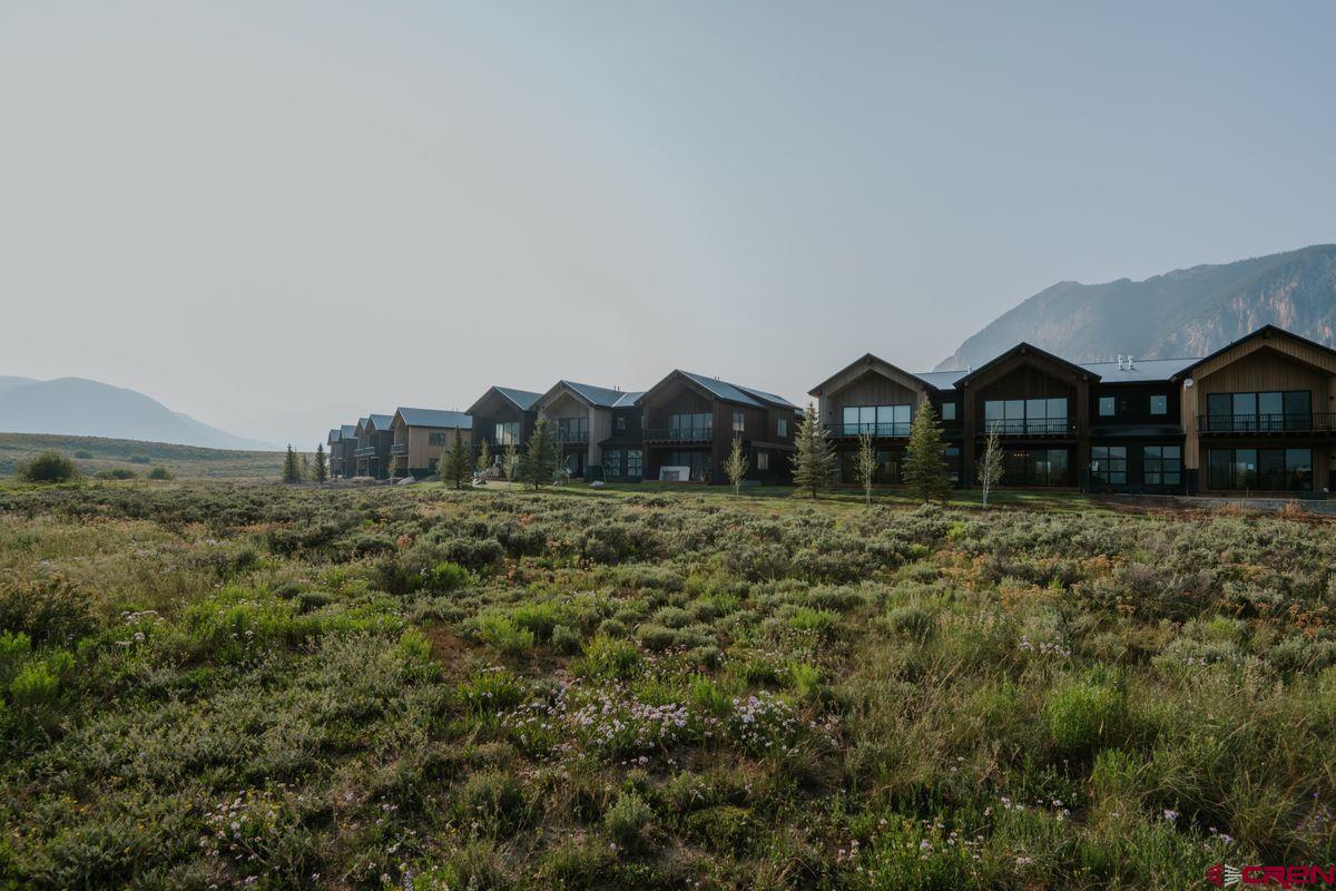 180 Elk Valley Road, Unit 124 Crested Butte, CO 81224 - Photo 23 of 23 a view of a house with a yard and sitting area