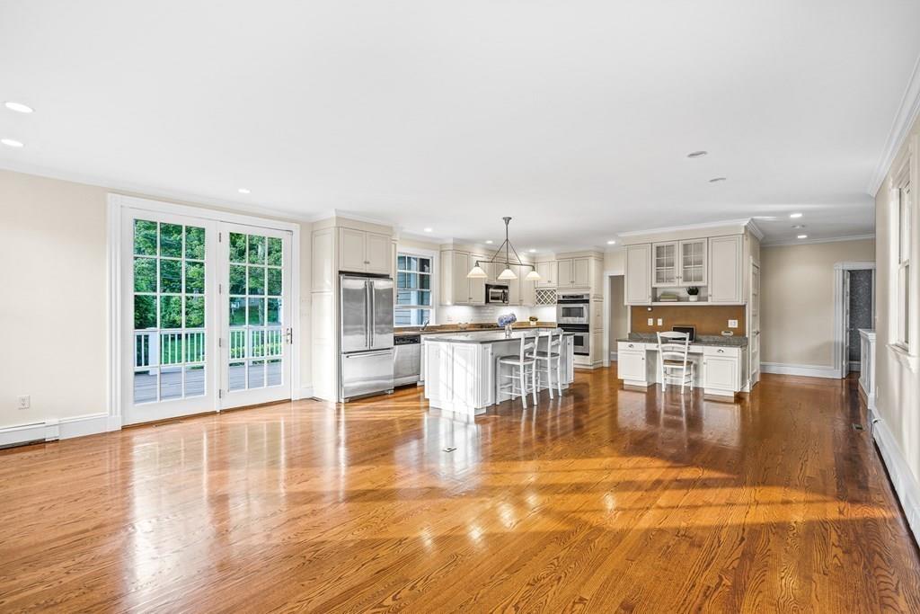 8 Garden Road Wellesley, MA 02481 - Photo 11 of 30 a dining room with furniture floor to ceiling windows and kitchen view