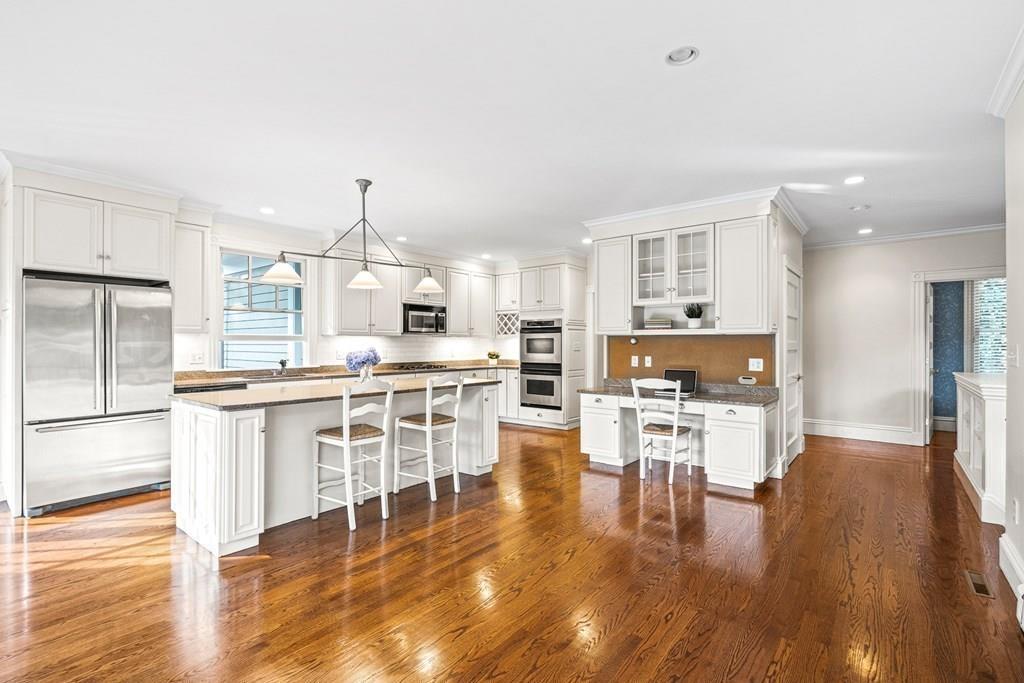 8 Garden Road Wellesley, MA 02481 - Photo 12 of 30 a open kitchen with white cabinets and stainless steel appliances