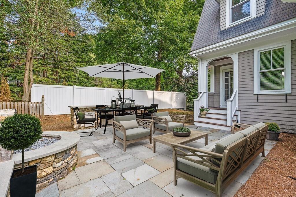 8 Garden Road Wellesley, MA 02481 - Photo 28 of 30 a view of a patio with couches and table under an umbrella