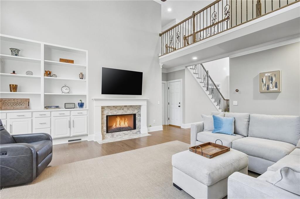 5318 Tallgrass Way Kennesaw, GA 30152 - Photo 16 of 70 a living room with furniture a fireplace and a flat screen tv