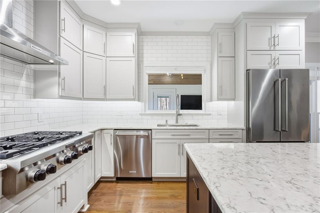 5318 Tallgrass Way Kennesaw, GA 30152 - Photo 22 of 70 a kitchen with stainless steel appliances granite countertop a sink stove and refrigerator