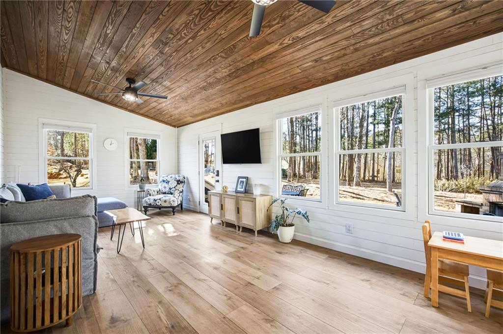 5318 Tallgrass Way Kennesaw, GA 30152 - Photo 25 of 70 a living room with furniture a flat screen tv and a fireplace