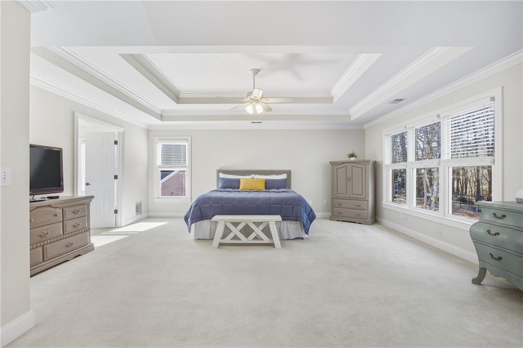 5318 Tallgrass Way Kennesaw, GA 30152 - Photo 31 of 70 a spacious bedroom with a bed and flat screen tv