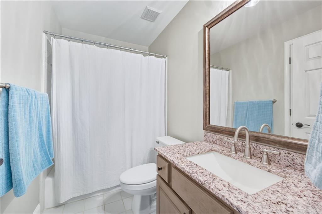 5318 Tallgrass Way Kennesaw, GA 30152 - Photo 38 of 70 a bathroom with a granite countertop sink and a mirror