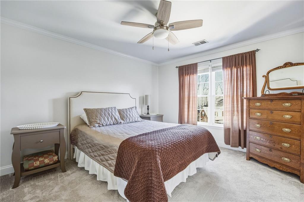 5318 Tallgrass Way Kennesaw, GA 30152 - Photo 42 of 70 a bedroom with a bed and a dresser