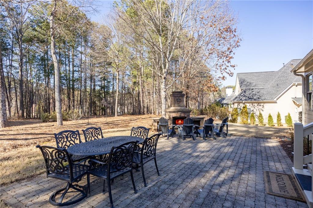 5318 Tallgrass Way Kennesaw, GA 30152 - Photo 49 of 70 a view of a patio with table and chairs with wooden floor and fence