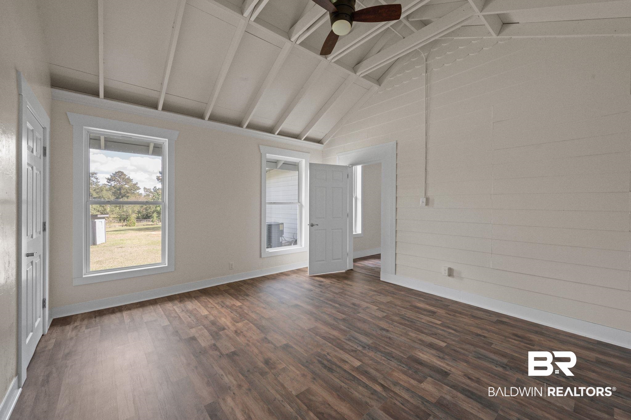 20037 County Road 33 Fairhope, AL 36532 - Photo 50 of 79 Unfurnished room with ceiling fan, high vaulted ceiling, beam ceiling, and dark hardwood / wood-style flooring