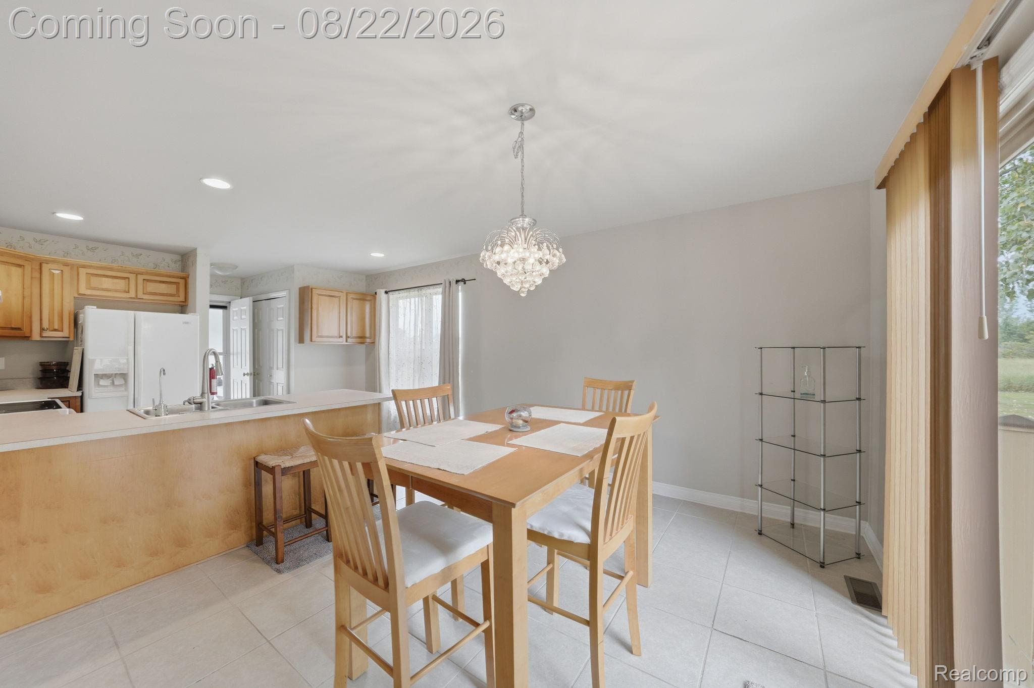 1301 Palms Road Columbus, MI 48063 - Photo 25 of 51 Open-concept kitchen and dining area featuring a crystal chandelier, recessed lighting, and tile flooring