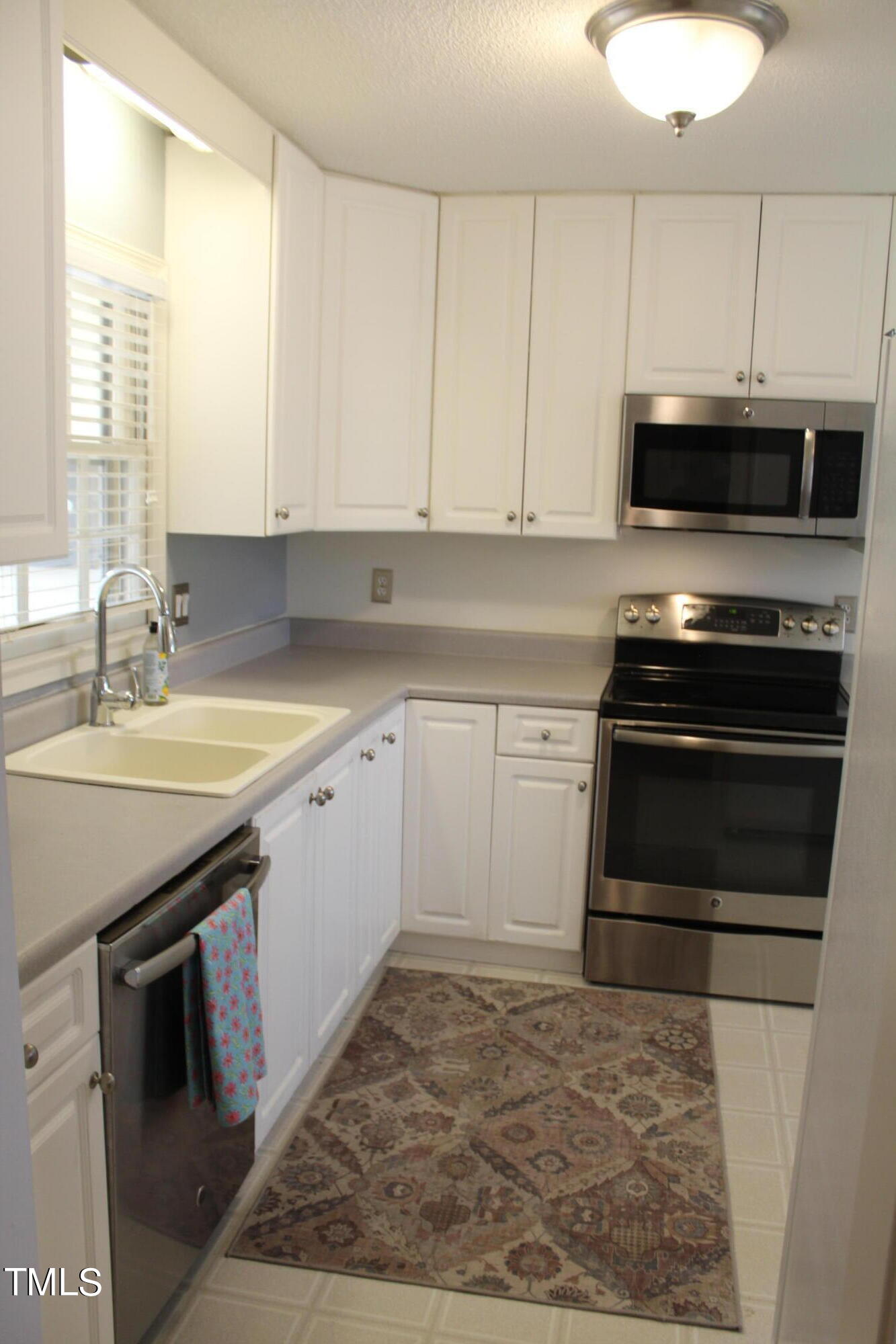 3508 Morningside Drive Raleigh, NC 27607 - Photo 25 of 58 a kitchen with a sink stove and cabinets