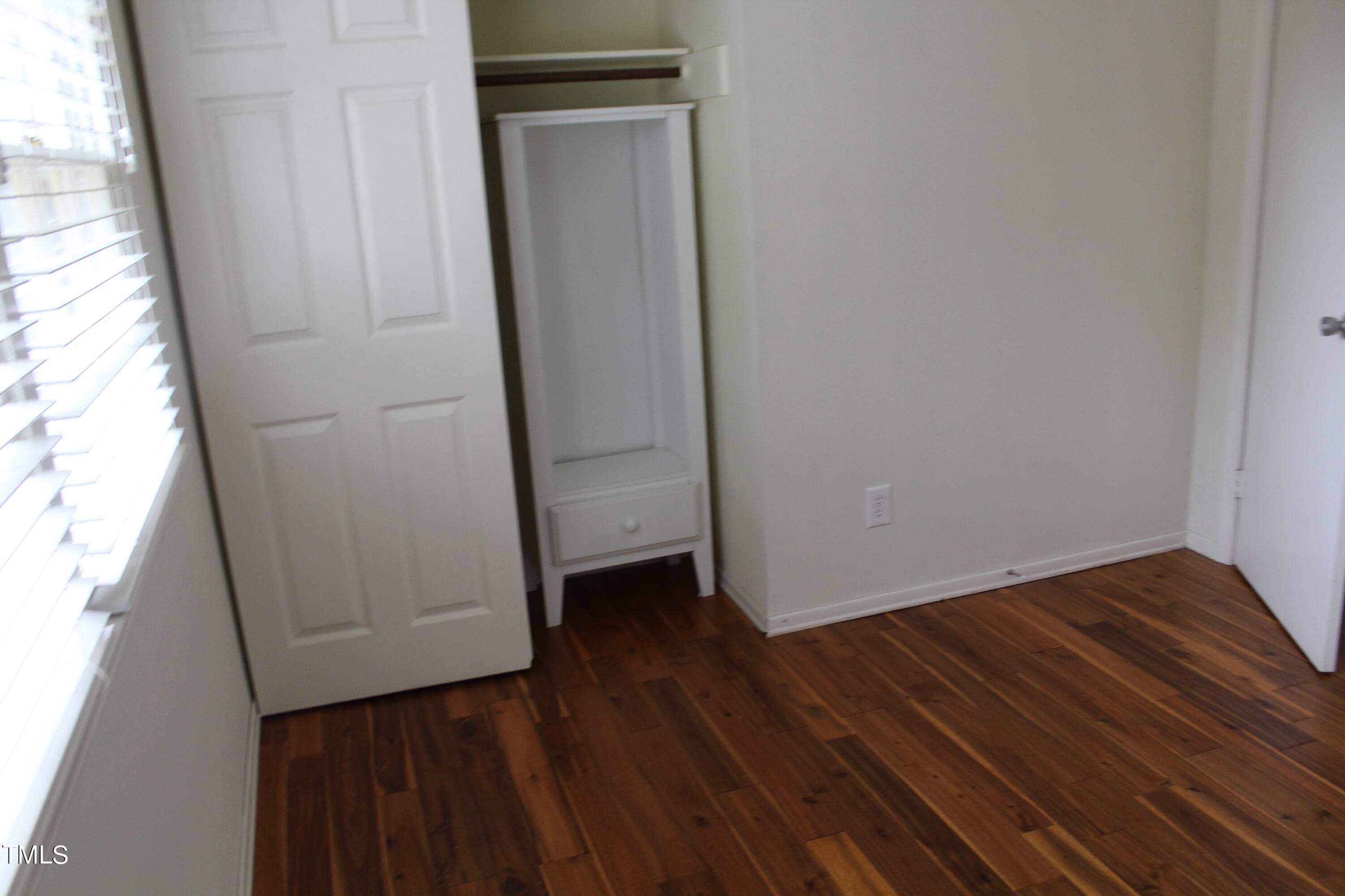 3508 Morningside Drive Raleigh, NC 27607 - Photo 47 of 58 a view of an empty room with wooden floor and a window