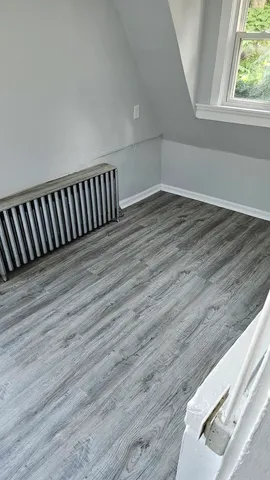 an empty room with wooden floor