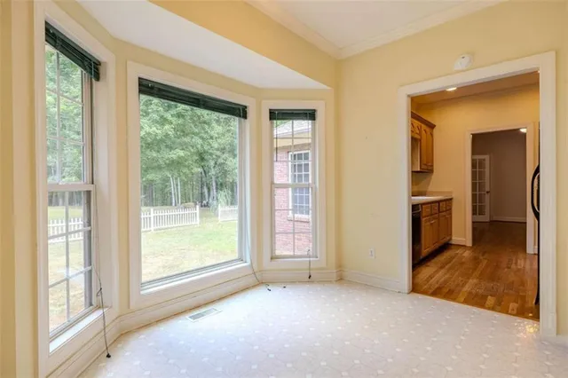 a view of empty room with a fireplace and windows