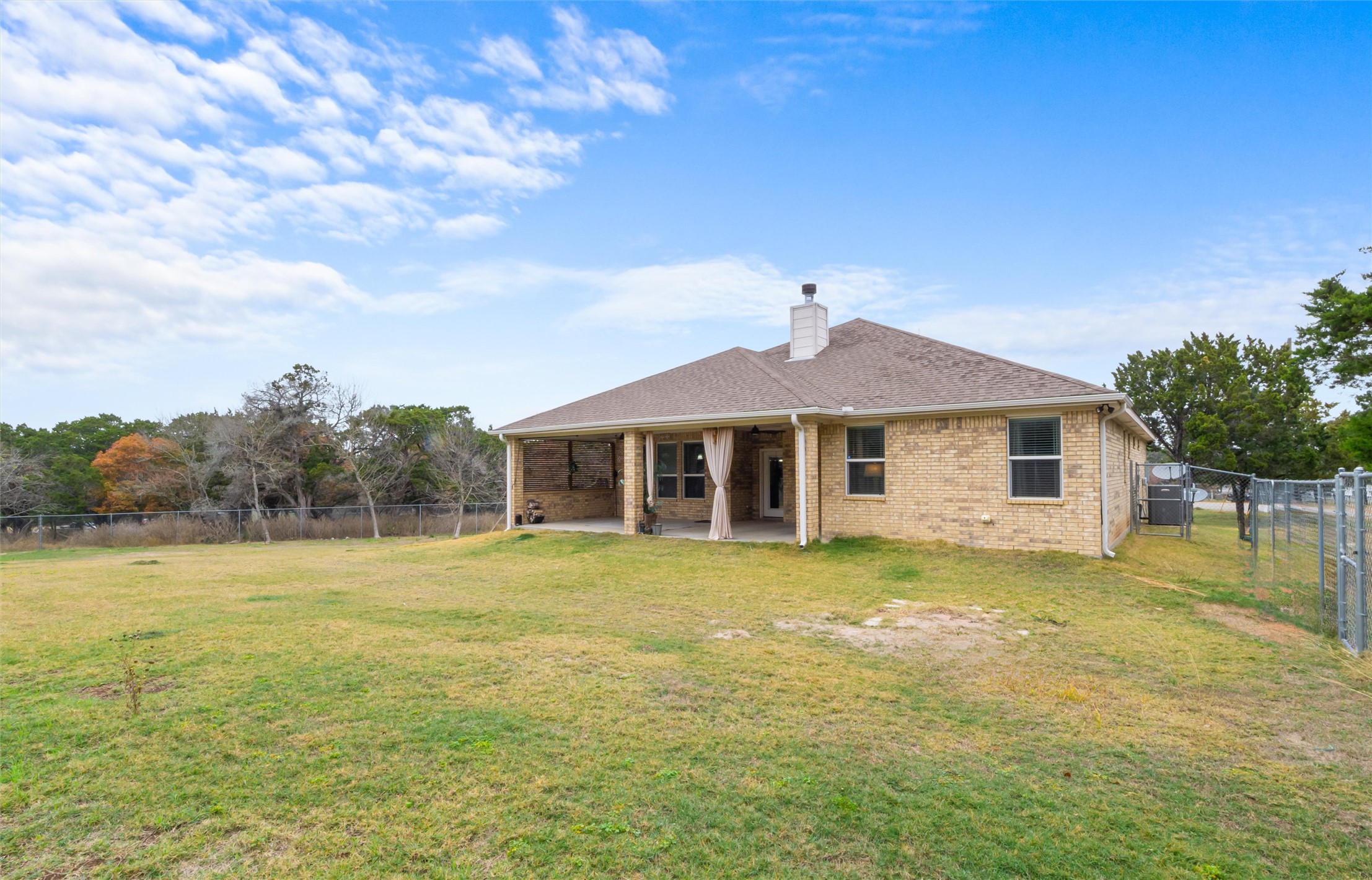 16017 Toby Court Temple, TX 76502 - Photo 25 of 33 Rear view of house with a fenced backyard, a patio area, brick siding, and a chimney