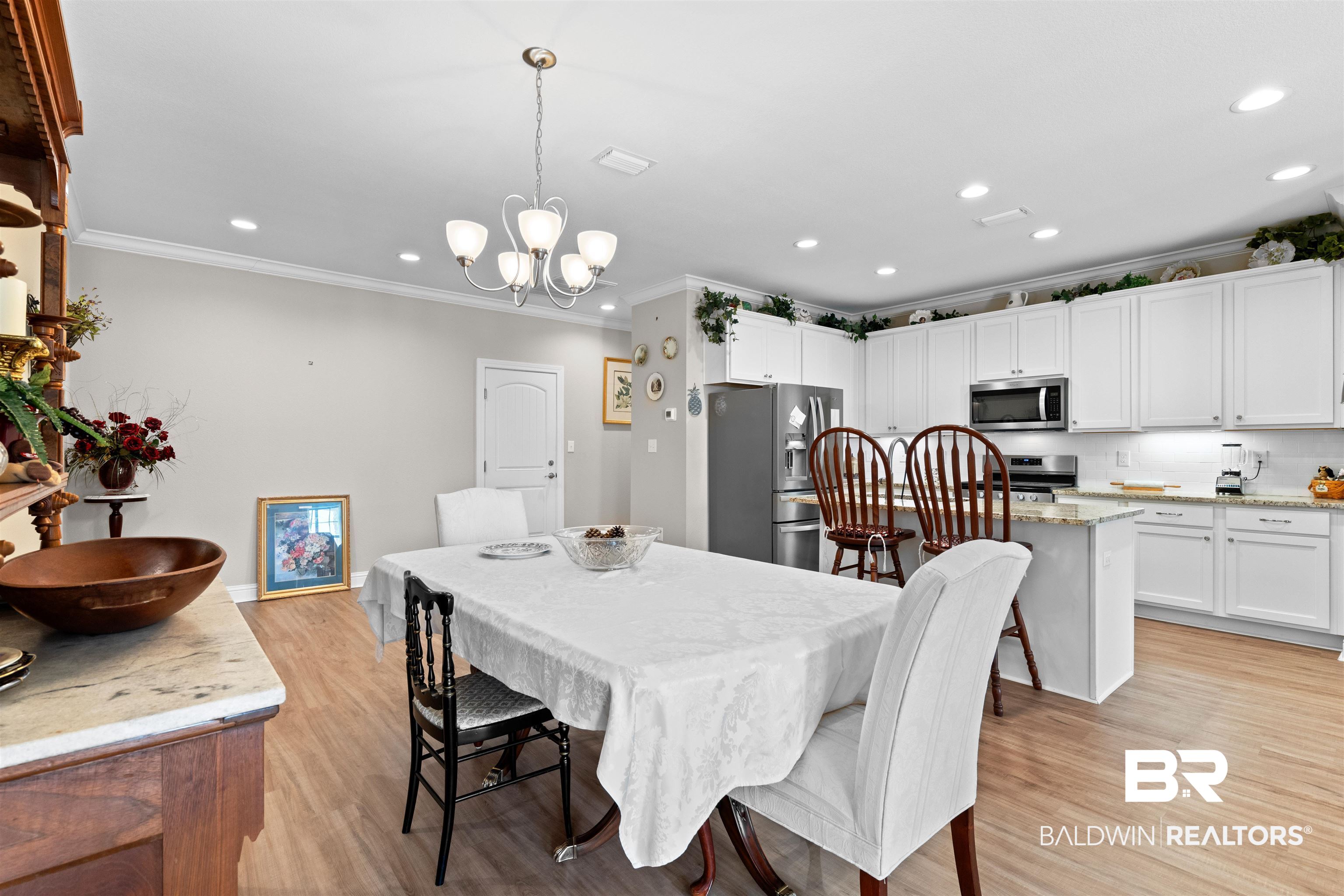 301 Holmes Avenue, Unit 301 Foley, AL 36535 - Photo 17 of 54 Dining space featuring a notable chandelier, recessed lighting, light wood-style flooring, and ornamental molding