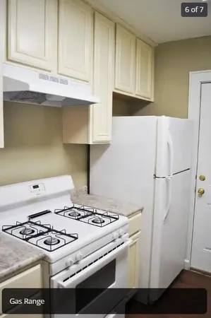a kitchen with granite countertop a stove and a refrigerator