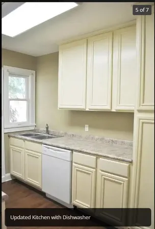 a kitchen with stainless steel appliances granite countertop a sink a stove and cabinets