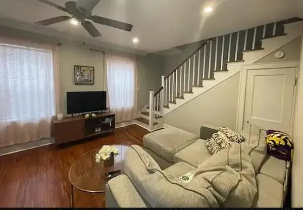 a living room with furniture and a flat screen tv