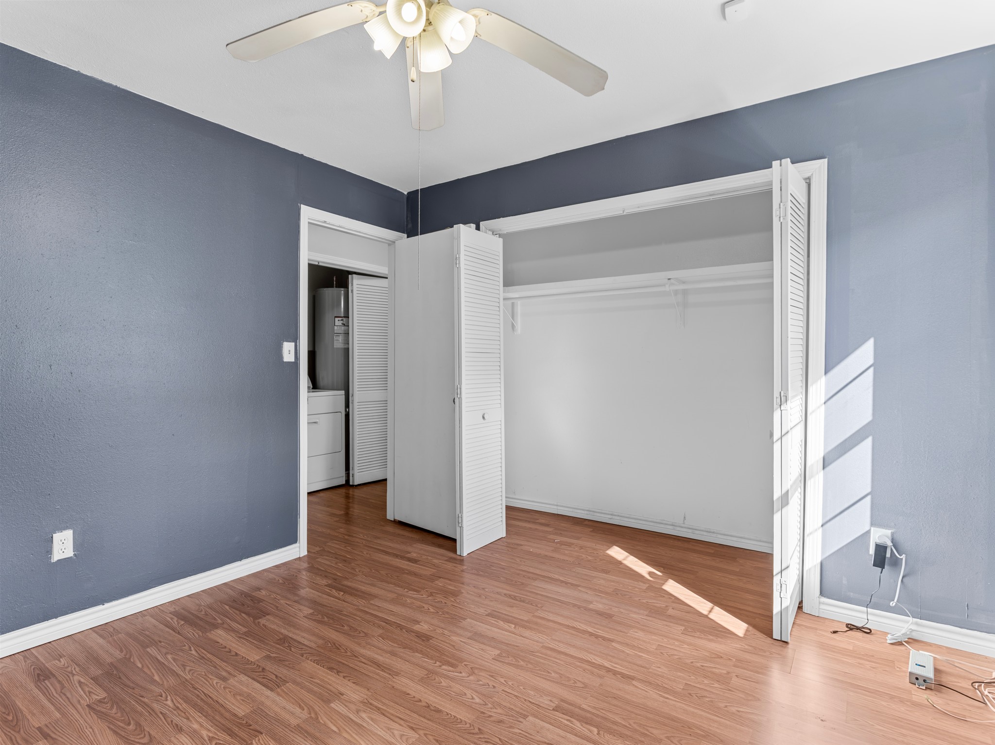 219 Beecher Avenue Palacios, TX 77465 - Photo 13 of 23 a view of an empty room with wooden floor and a window