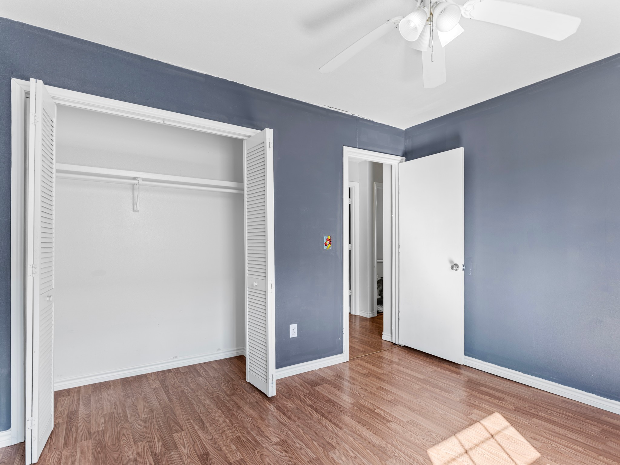 219 Beecher Avenue Palacios, TX 77465 - Photo 17 of 23 a view of an empty room with wooden floor