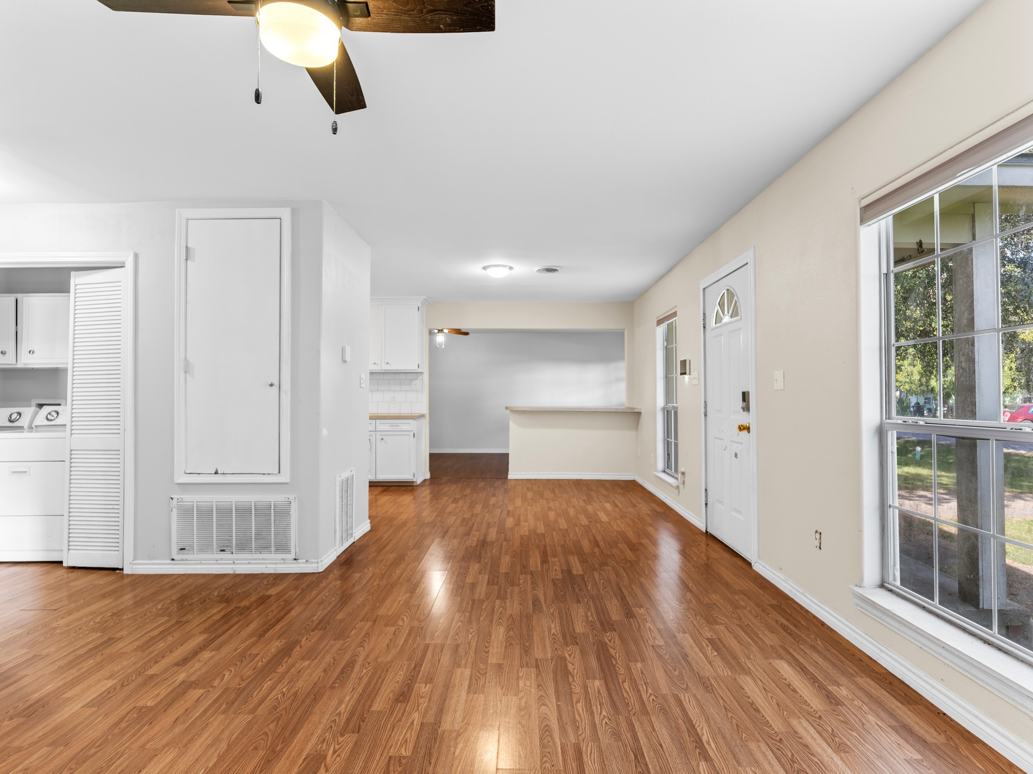219 Beecher Avenue Palacios, TX 77465 - Photo 5 of 23 a view of kitchen and empty room with wooden floor