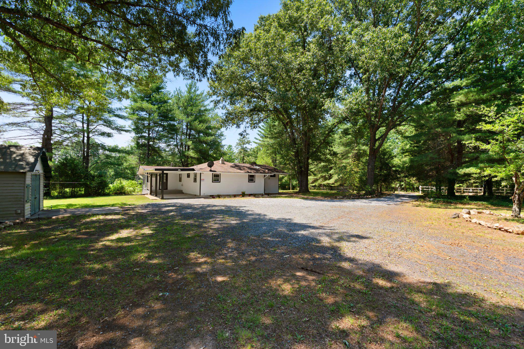 8405 Shirley Road Spotsylvania, VA 22551 - Photo 4 of 42 a front view of a house with a yard and tree s