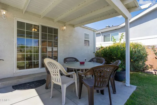 a view of a dining room with furniture and garden