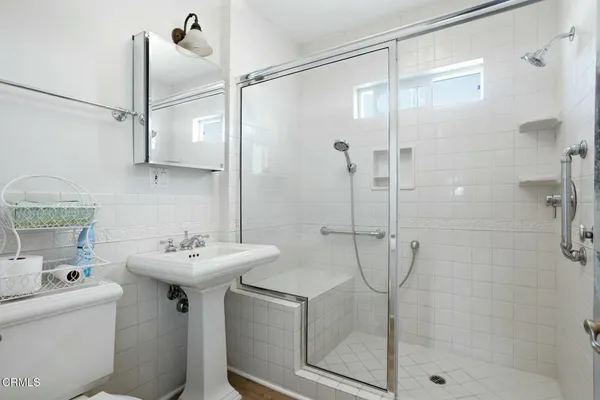 a bathroom with a sink toilet and shower