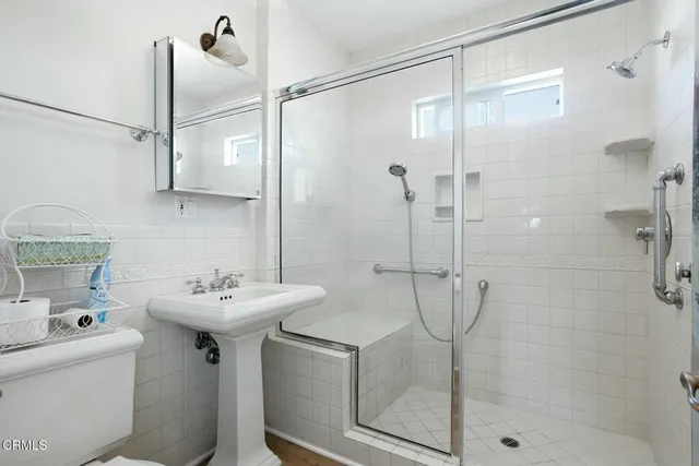 a bathroom with a sink toilet and shower