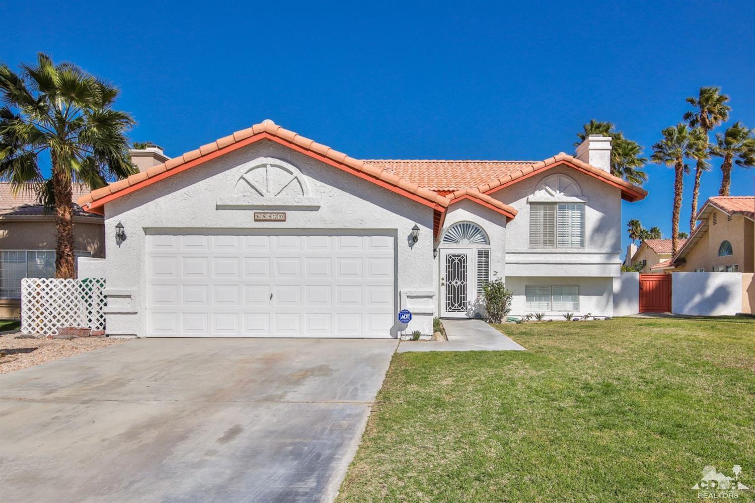68420 Risueno Road Cathedral City, CA 92234 - Photo 1 of 37 a front view of a house with a yard and garage