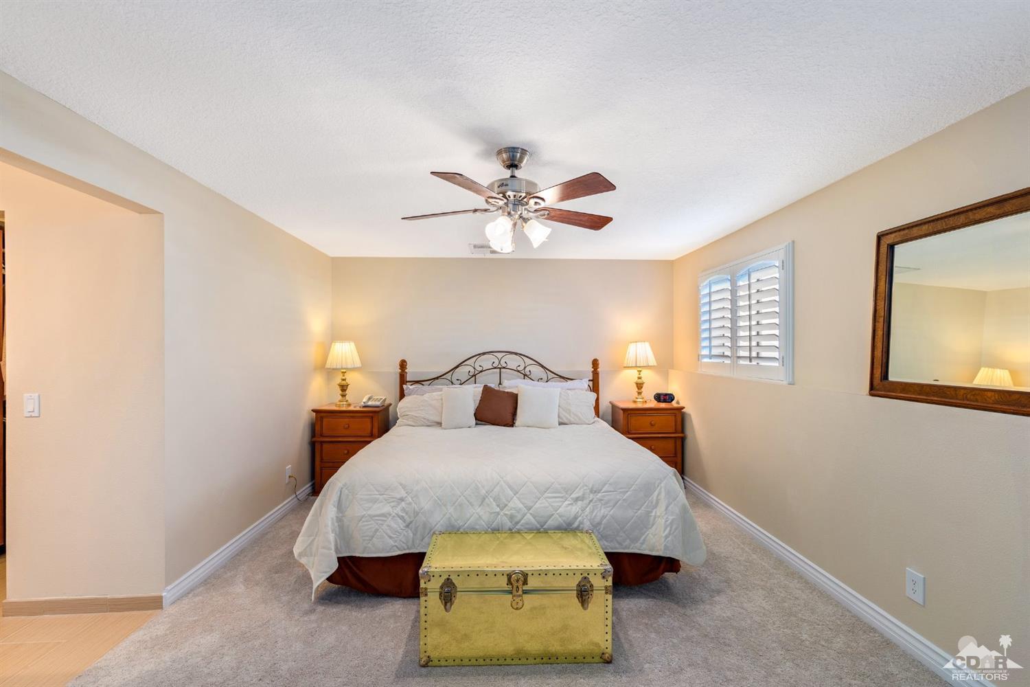 68420 Risueno Road Cathedral City, CA 92234 - Photo 17 of 37 a bedroom with a bed and window