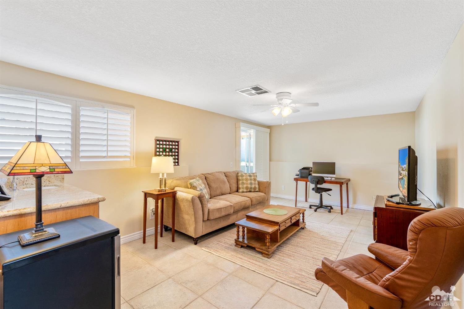 68420 Risueno Road Cathedral City, CA 92234 - Photo 22 of 37 a living room with furniture a flat screen tv and a window