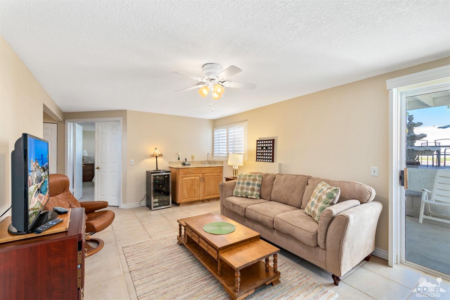 68420 Risueno Road Cathedral City, CA 92234 - Photo 23 of 37 a living room with furniture and a chandelier
