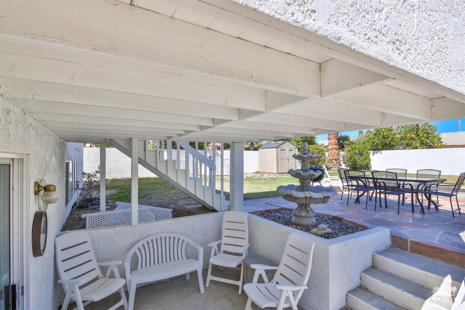 68420 Risueno Road Cathedral City, CA 92234 - Photo 36 of 37 a view of a patio with a table chairs and backyard