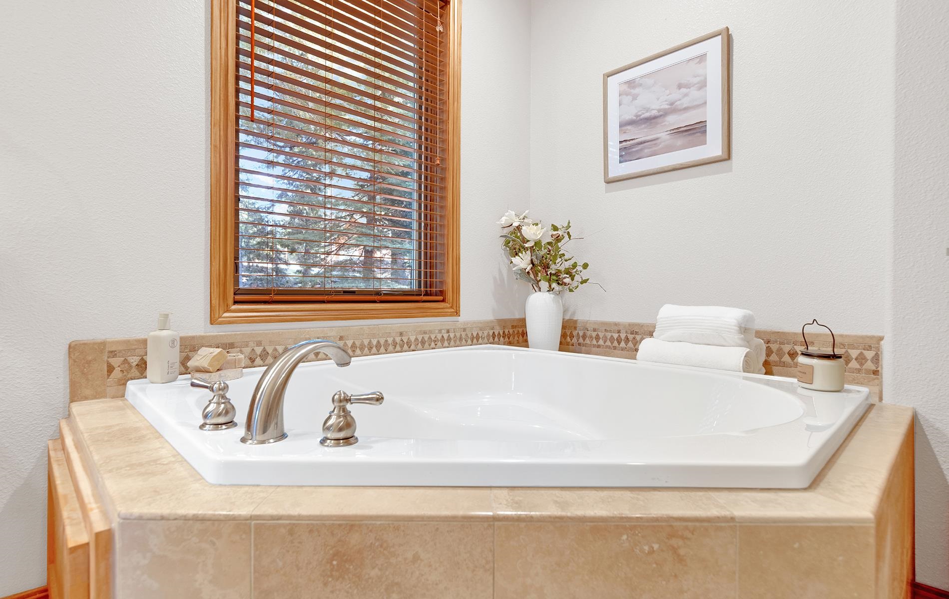 627 Deep Forest Road Lake Almanor, CA 96137 - Photo 16 of 29 a bathroom with a bathtub and a window