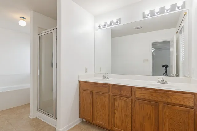 a bathroom with a double vanity sink and a mirror