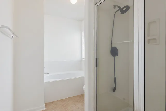 a view of a room that has a window and a fan