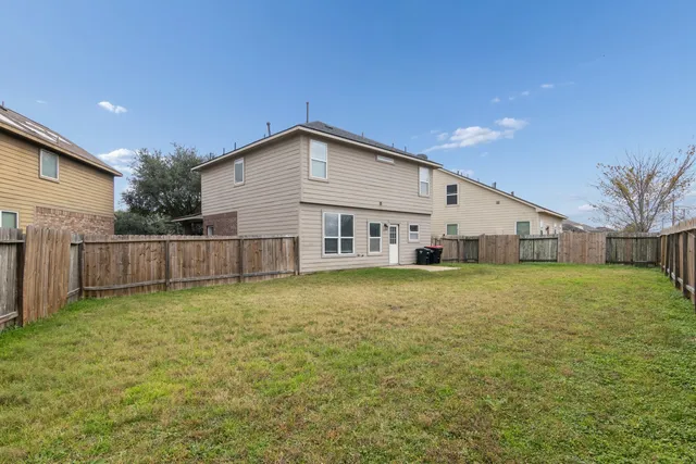 a view of a house with a backyard