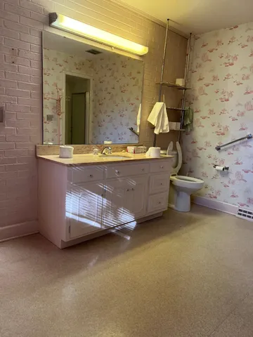 a front view of a building with a garden