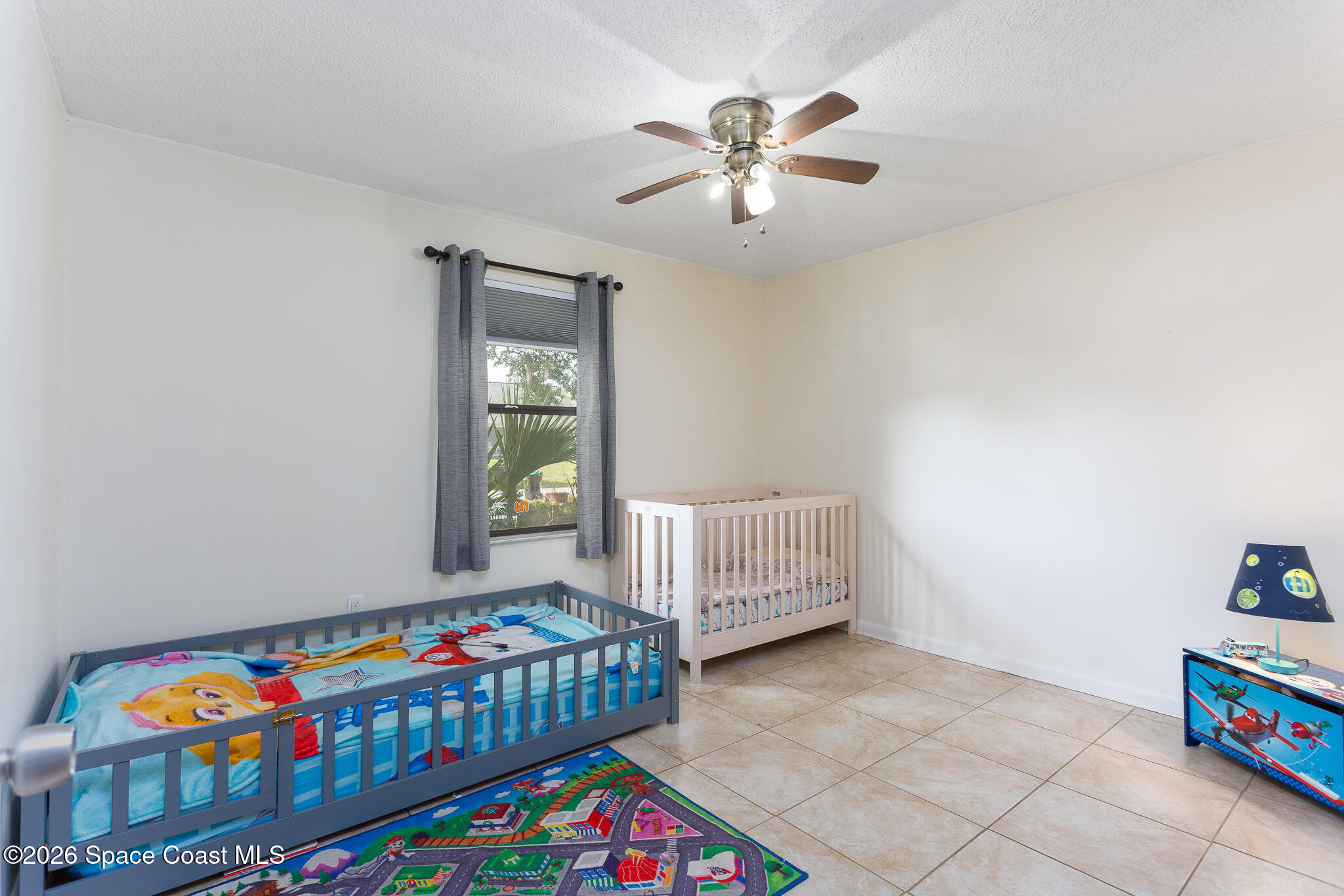 2255 Ladner Road Northeast Palm Bay, FL 32907 - Photo 11 of 22 a bedroom with furniture and a baby crib