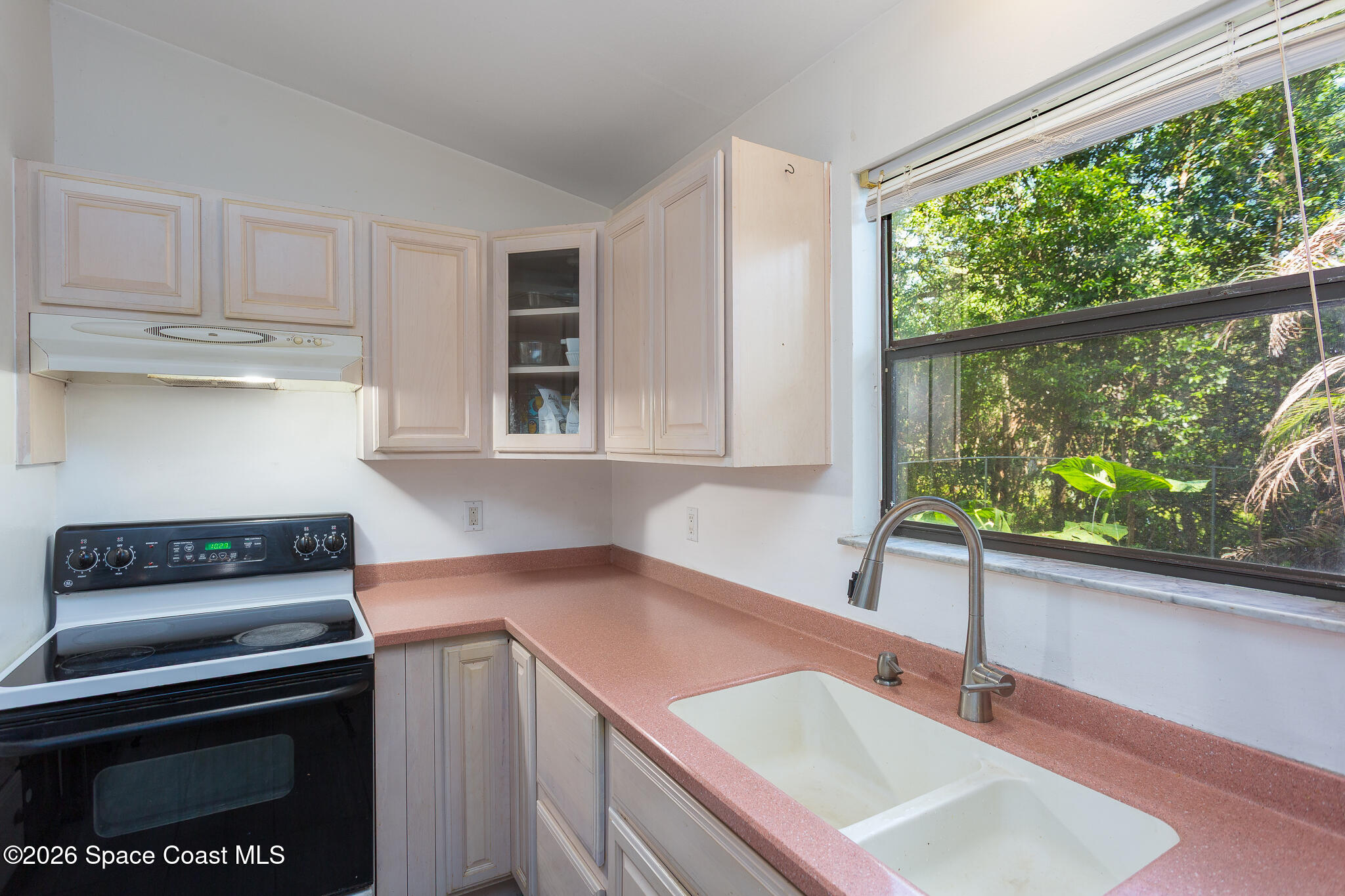 2255 Ladner Road Northeast Palm Bay, FL 32907 - Photo 12 of 22 a kitchen with a sink stove and cabinets